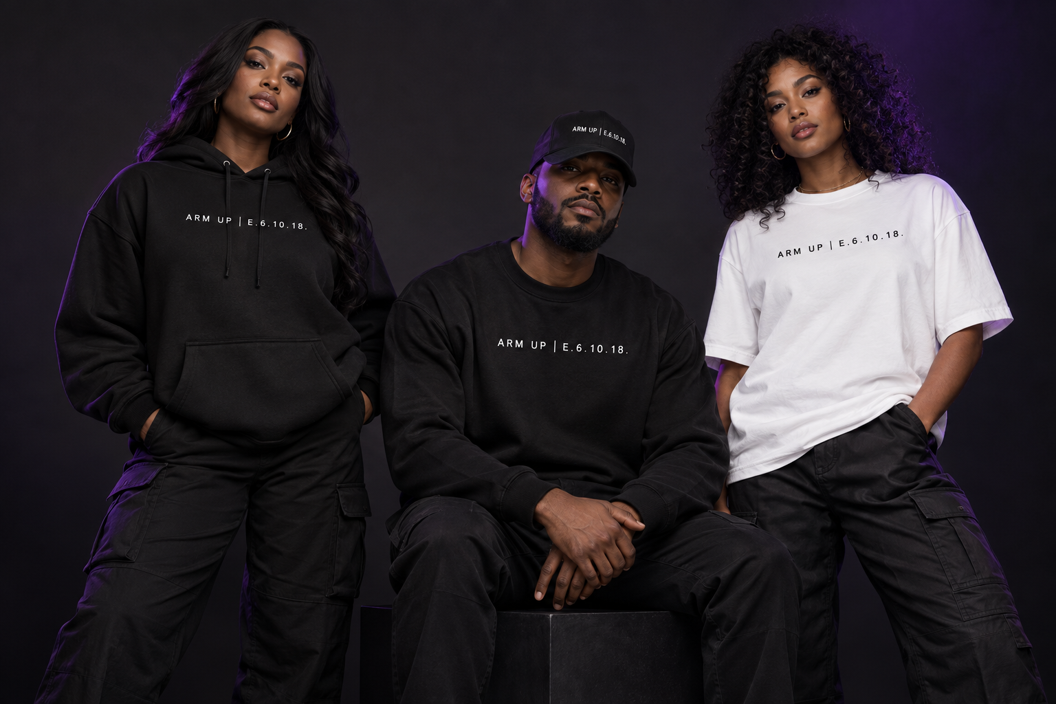 Models wearing black and white ARM UP apparel, including a hoodie, crewneck sweatshirt, T-shirt, and cap