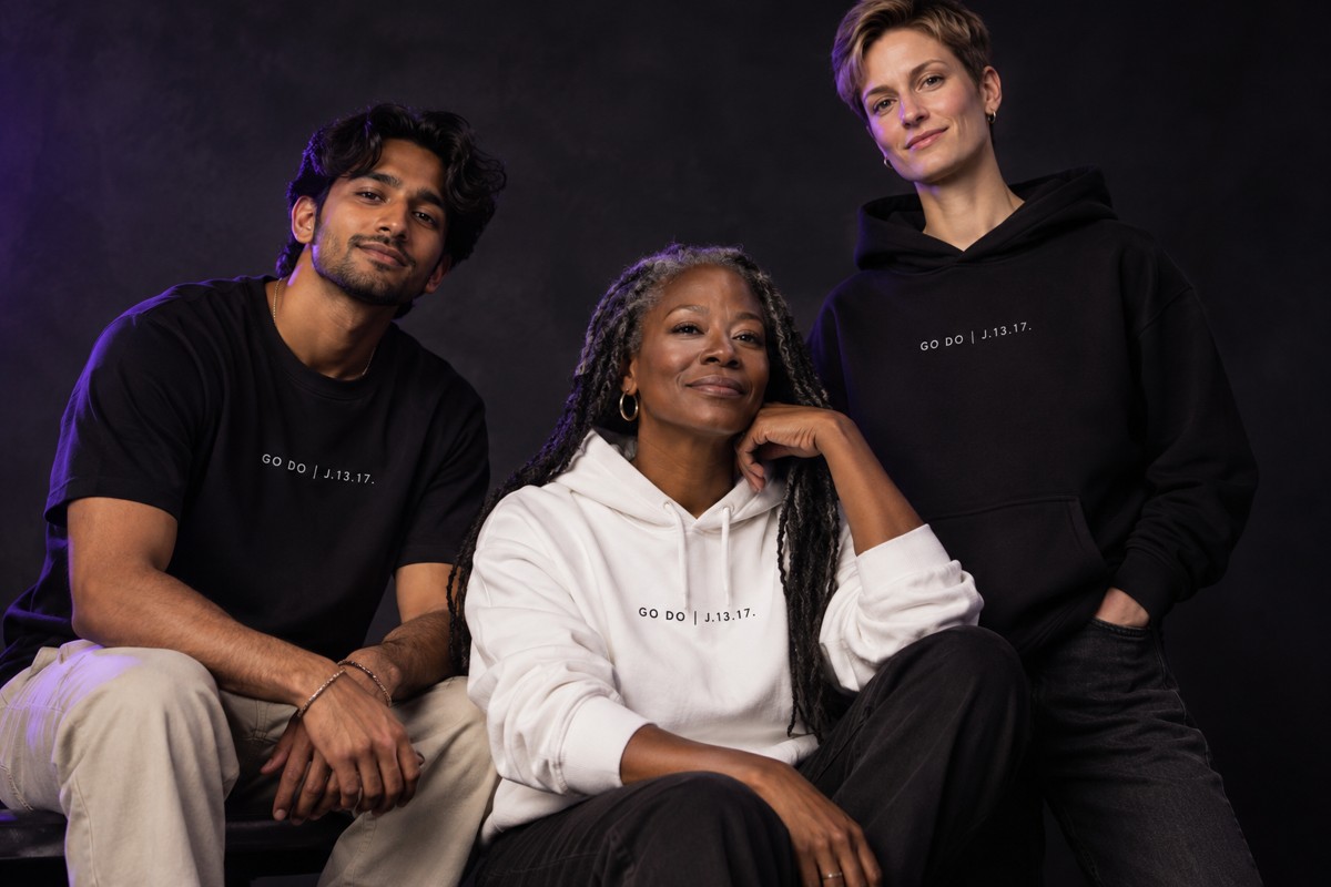A diverse group of models wearing black and white Calling apparel